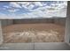 This backyard is enclosed with a privacy wall, providing space for relaxation at 9525 W Luxton Ln, Tolleson, AZ 85353