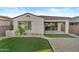 A manicured backyard features artificial turf, a low maintenance landscaping, and a covered patio at 9624 E Twinkle Cir, Mesa, AZ 85212