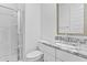 This bathroom features granite countertops, a tiled shower surround, and a white cabinet at 9624 E Twinkle Cir, Mesa, AZ 85212