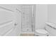 This bathroom features a glass shower, grey granite countertop, white cabinets, and a toilet at 9624 E Twinkle Cir, Mesa, AZ 85212