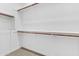 Empty walk-in closet with wooden rails and shelves at 9624 E Twinkle Cir, Mesa, AZ 85212