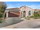 Inviting single-story home with a well-maintained front yard and a two car garage at 9624 E Twinkle Cir, Mesa, AZ 85212