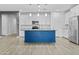 Contemporary kitchen boasts white cabinets, stainless steel appliances, and a stylish blue island at 9624 E Twinkle Cir, Mesa, AZ 85212