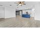 Bright, open-concept living space flows seamlessly into a modern kitchen with a blue island at 9624 E Twinkle Cir, Mesa, AZ 85212