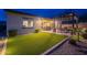 Expansive backyard with lush artificial turf, a pergola, and a covered patio, perfect for outdoor living at 10254 W Bent Tree Dr, Peoria, AZ 85383