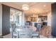 Open-concept breakfast nook with backyard views, a pendant light, and adjacent kitchen and living areas at 10254 W Bent Tree Dr, Peoria, AZ 85383