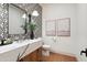 Stylish bathroom boasts bold, patterned tile, a marble countertop, and natural accents at 12218 N 104Th St, Scottsdale, AZ 85260