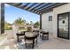 Comfortable outdoor seating area with brick fireplace under pergola with view of lawn at 12218 N 104Th St, Scottsdale, AZ 85260