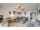 Inviting living room with comfortable seating, ceiling fan, and dining area in the background at 13408 N 25Th Dr, Phoenix, AZ 85029