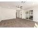 Main bedroom featuring carpet flooring, a ceiling fan, and access to a private bathroom and closet at 13447 S 155Th St, Gilbert, AZ 85296