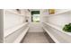 Pantry featuring rows of white shelves for storage and a small window for natural light at 13447 S 155Th St, Gilbert, AZ 85296