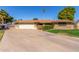 Well maintained home with a large front yard, mature landscaping and driveway at 1426 E Indigo Cir, Mesa, AZ 85203