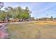 Spacious backyard featuring mature trees, play structures, and an open lawn at 15076 W Belmont Dr, Casa Grande, AZ 85194