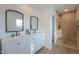 Bathroom boasts a double sink vanity, sleek black fixtures, and a walk-in tiled shower at 15076 W Belmont Dr, Casa Grande, AZ 85194