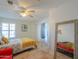 Bright bedroom boasts tile flooring, ample natural light, and access to hallway and closet at 15076 W Belmont Dr, Casa Grande, AZ 85194