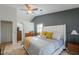 Comfortable bedroom features a white bed frame, a gray accent wall, and tiled floors at 15076 W Belmont Dr, Casa Grande, AZ 85194