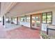 Inviting covered patio featuring brick flooring, and dual doors leading inside at 15076 W Belmont Dr, Casa Grande, AZ 85194