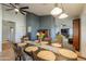 Spacious dining area with seating for eight, chandelier, and an open floor plan at 15076 W Belmont Dr, Casa Grande, AZ 85194