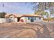 Exterior view of the house displaying desert landscaping and a small outdoor fountain at 15076 W Belmont Dr, Casa Grande, AZ 85194