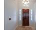 Foyer featuring a wood door, tile flooring and white paint at 15076 W Belmont Dr, Casa Grande, AZ 85194