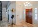 Foyer with wood door, light fixtures, and unique decor, creating a warm entryway at 15076 W Belmont Dr, Casa Grande, AZ 85194