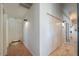 View of the hallway with tile flooring, a closet, and sconce lighting at 15076 W Belmont Dr, Casa Grande, AZ 85194