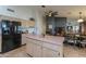 Spacious kitchen featuring a central island, black refrigerator, and seamless flow to dining area at 15076 W Belmont Dr, Casa Grande, AZ 85194
