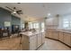 Open kitchen connected to the dining room, featuring an island and light wood cabinets at 15076 W Belmont Dr, Casa Grande, AZ 85194