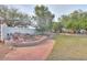 Landscaped backyard featuring rock features, cacti, and mature trees at 15076 W Belmont Dr, Casa Grande, AZ 85194