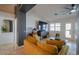 Living room featuring high ceilings and a large TV at 15076 W Belmont Dr, Casa Grande, AZ 85194