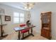 Office space with a vintage desk and a glass cabinet at 15076 W Belmont Dr, Casa Grande, AZ 85194
