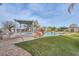 Stunning pool and spa surrounded by lush landscaping and rock features at 15076 W Belmont Dr, Casa Grande, AZ 85194