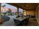 Inviting covered patio with an outdoor dining area overlooking the golf course and vibrant sunset at 16690 W Windsor Ave, Goodyear, AZ 85395