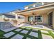 Outdoor patio with a stone grill, dining table, and well-manicured grass squares, ideal for relaxation at 1957 W Lonesome Trl, Phoenix, AZ 85085