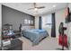 Bedroom with ceiling fan, grey accent wall, tv, and gaming station at 1957 W Lonesome Trl, Phoenix, AZ 85085
