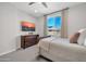 Relaxing bedroom with TV, dresser, and a cozy bed with soft bedding and natural light from the window at 1957 W Lonesome Trl, Phoenix, AZ 85085