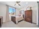Serene bedroom features a comfy bed, wood dresser, and a decorative mirror adding charm and character at 1957 W Lonesome Trl, Phoenix, AZ 85085