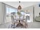 Well-lit dining area featuring a round table, stylish chairs, and a view of the backyard at 1957 W Lonesome Trl, Phoenix, AZ 85085