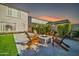 Cozy backyard fire pit area surrounded by Adirondack chairs, perfect for evening gatherings at 1957 W Lonesome Trl, Phoenix, AZ 85085
