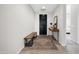 Inviting foyer with a dark wood door, bench seating, and stylish decor at 1957 W Lonesome Trl, Phoenix, AZ 85085