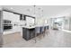 Modern kitchen boasts white cabinets, stainless steel appliances, and a large center island with seating at 1957 W Lonesome Trl, Phoenix, AZ 85085
