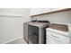 Well-organized laundry room with modern washer and dryer, ample storage space, and bright lighting at 1957 W Lonesome Trl, Phoenix, AZ 85085