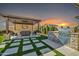 Backyard oasis featuring an outdoor kitchen, bar, and tv for entertaining and relaxation at 1957 W Lonesome Trl, Phoenix, AZ 85085