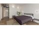 Cozy bedroom featuring modern lighting and a view into the bathroom at 207 W Clarendon Ave # B22, Phoenix, AZ 85013