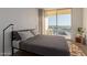 This is a bedroom with floor to ceiling window showing city view at 207 W Clarendon Ave # B22, Phoenix, AZ 85013