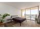 Bright bedroom with a large window that offers stunning views of the city skyline at 207 W Clarendon Ave # B22, Phoenix, AZ 85013