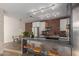 Bright kitchen boasts stainless steel appliances, brick backsplash, and eat-in dining space at 207 W Clarendon Ave # B22, Phoenix, AZ 85013