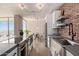 Stylish kitchen with stainless steel appliances, exposed brick, and a view into the dining area at 207 W Clarendon Ave # B22, Phoenix, AZ 85013