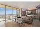 Open concept living room featuring access to a balcony and a view of the kitchen area at 207 W Clarendon Ave # B22, Phoenix, AZ 85013