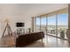 Bright living room with large windows, a balcony overlooking the city, and modern furnishings at 207 W Clarendon Ave # B22, Phoenix, AZ 85013